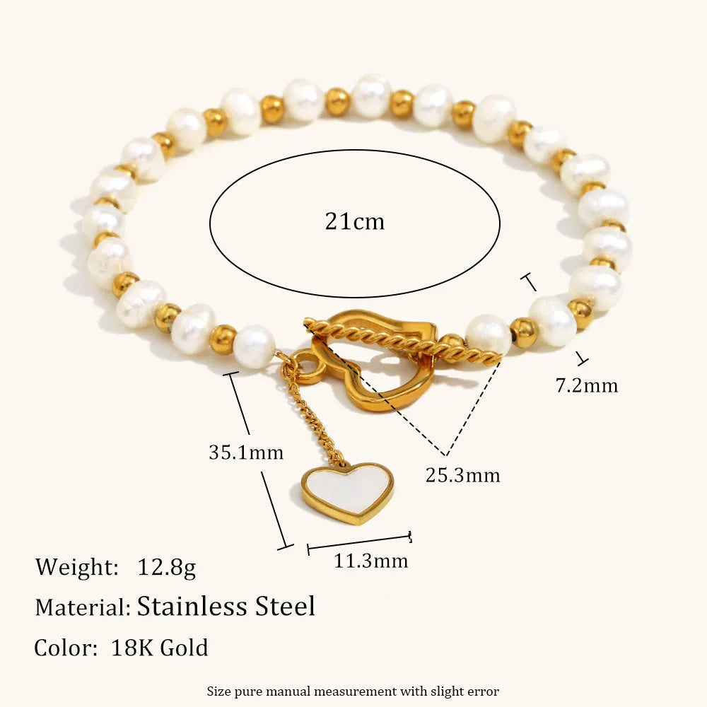 Gold pearl heart-shaped buckle bracelet on display