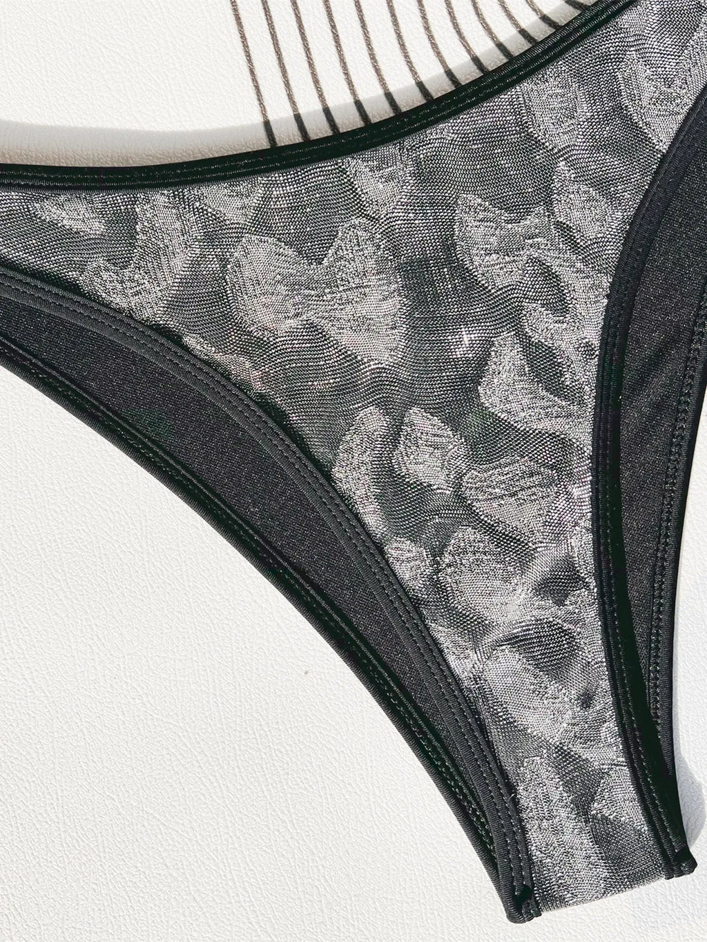 Black ladies bikini swimsuit with straps on a mannequin.