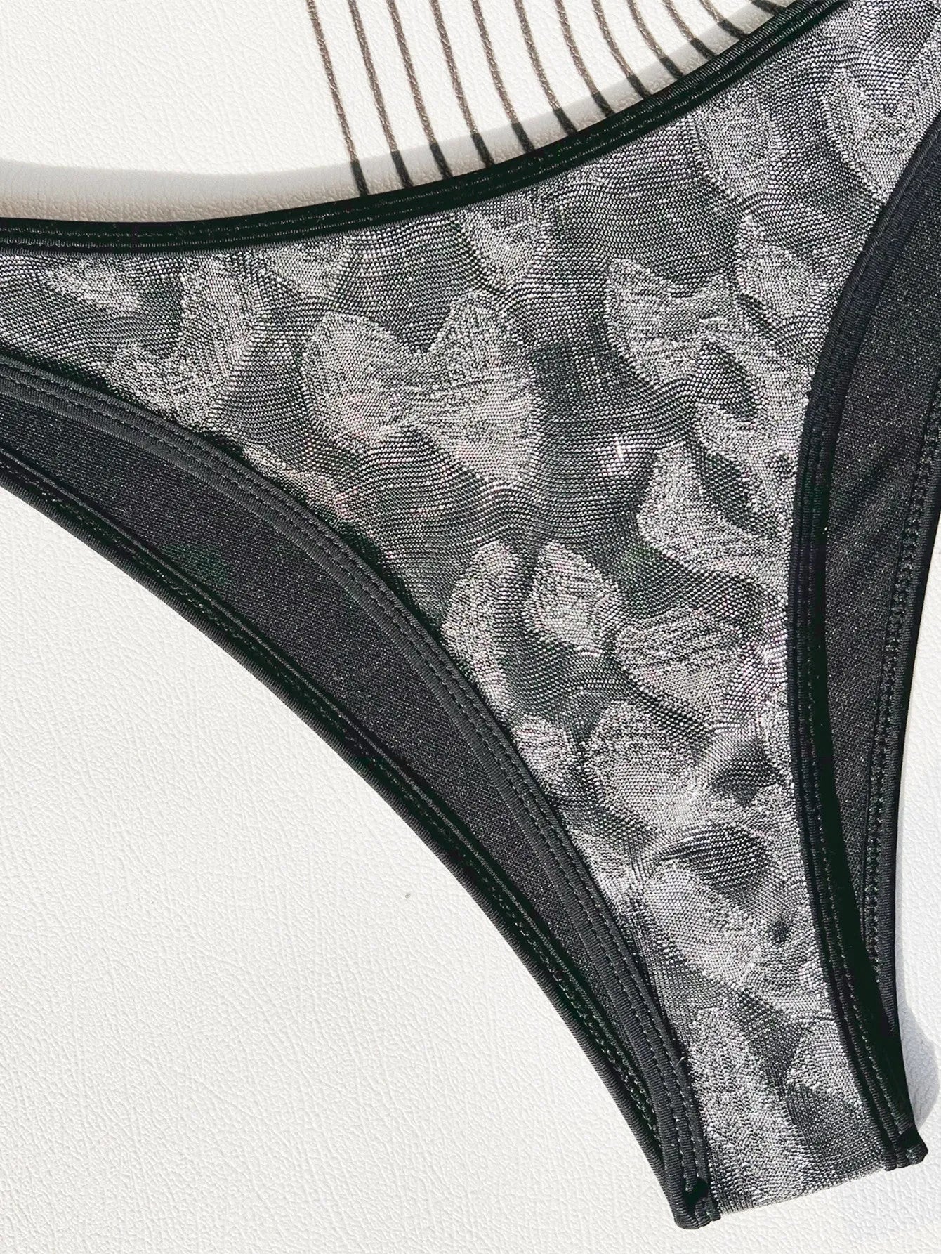 Black ladies bikini swimsuit with straps on a mannequin.