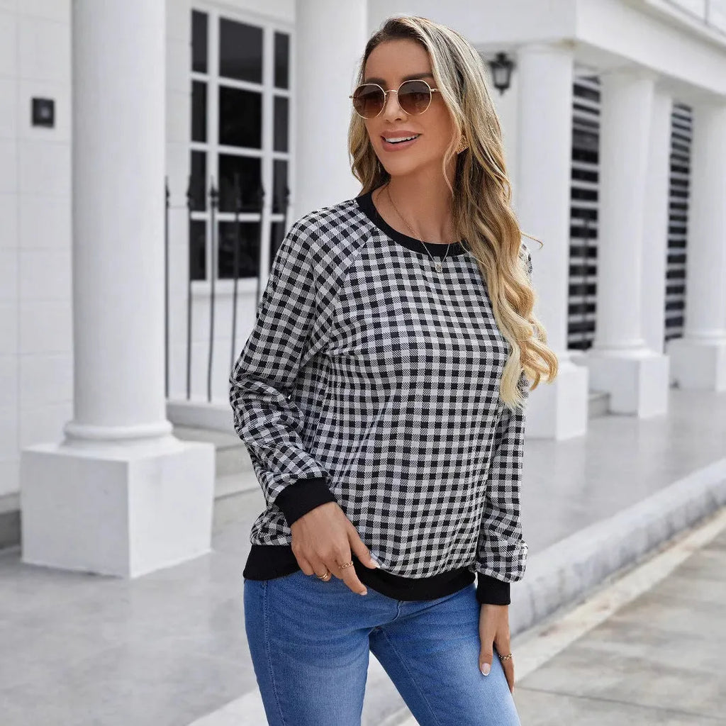 Black plaid and stripe pattern pullover sweater with long sleeves on mannequin