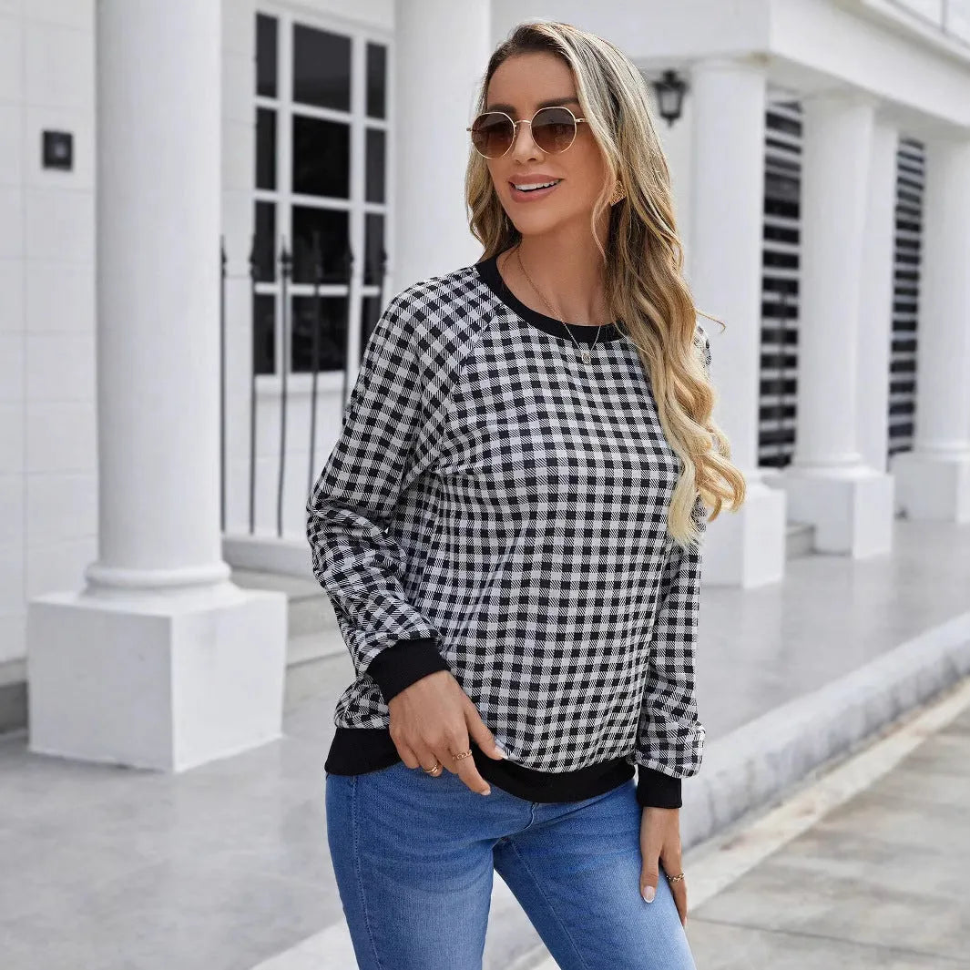 Black plaid and stripe pattern pullover sweater with long sleeves on mannequin