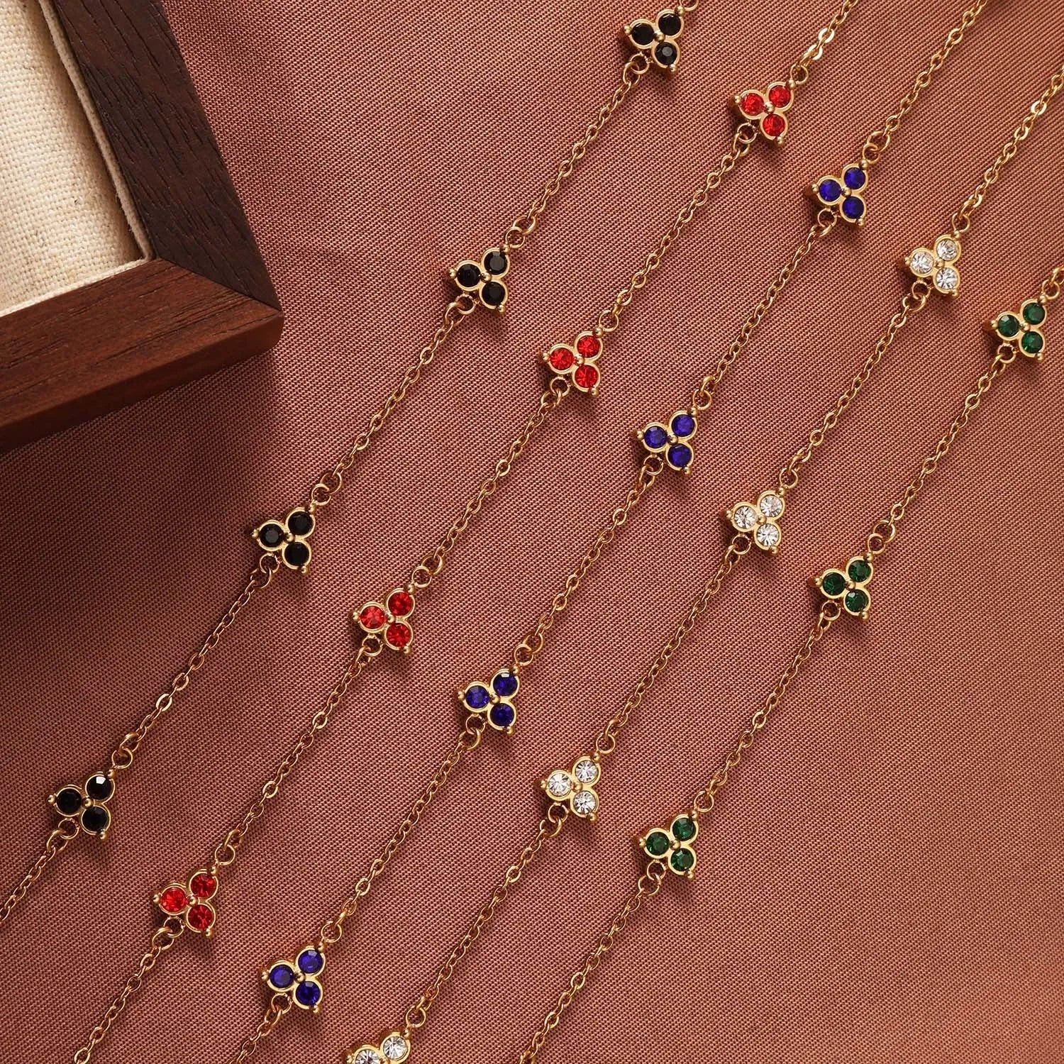 Geometric triangle women's bracelet in stainless steel with a choice of coloured centre stones on a gold or steel band.