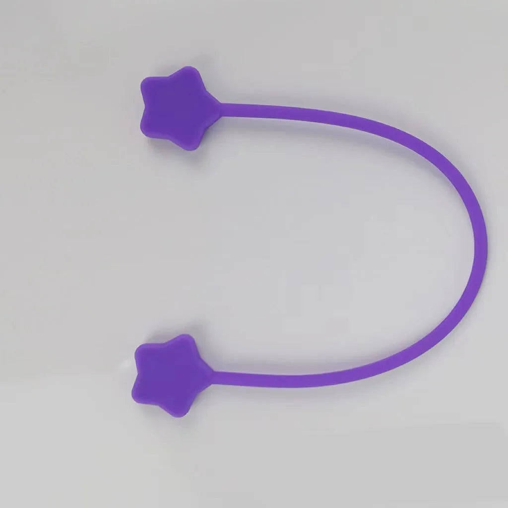 Purple silicone star-shaped magnet winder for clipping onto and organising headphone or phone charging cables.
