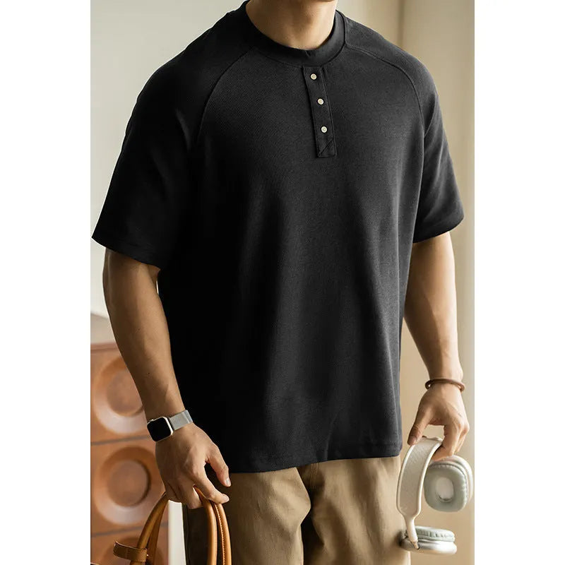 Women's loose grey casual pullover top with raglan sleeves on a hanger.