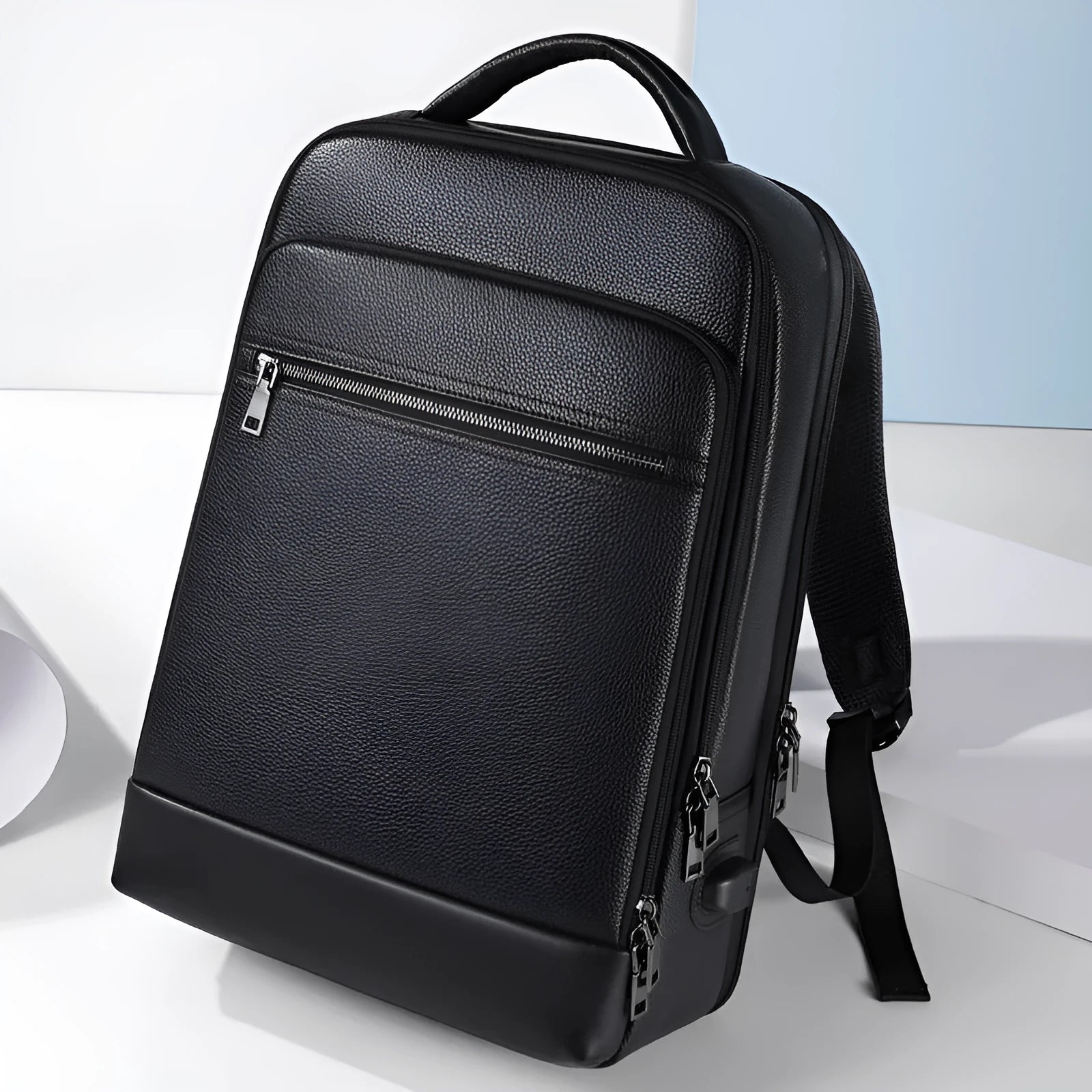 Black leather men's business computer backpack with curved shoulder straps and sewing line details