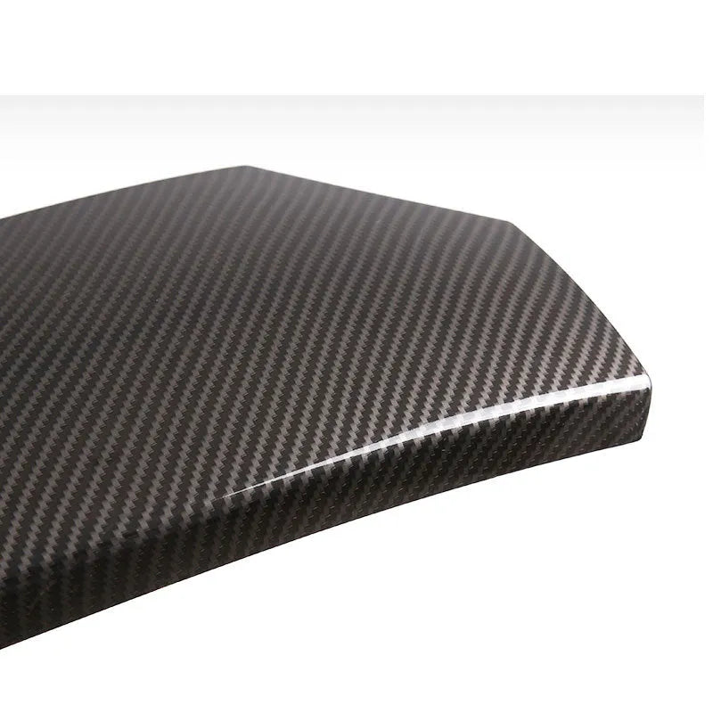 Set of three black ABS protective covers with a carbon fibre weave pattern for car armrest boxes.