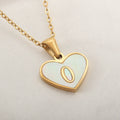 Gold plated heart pendant necklace with white shell centre on a stainless steel chain.