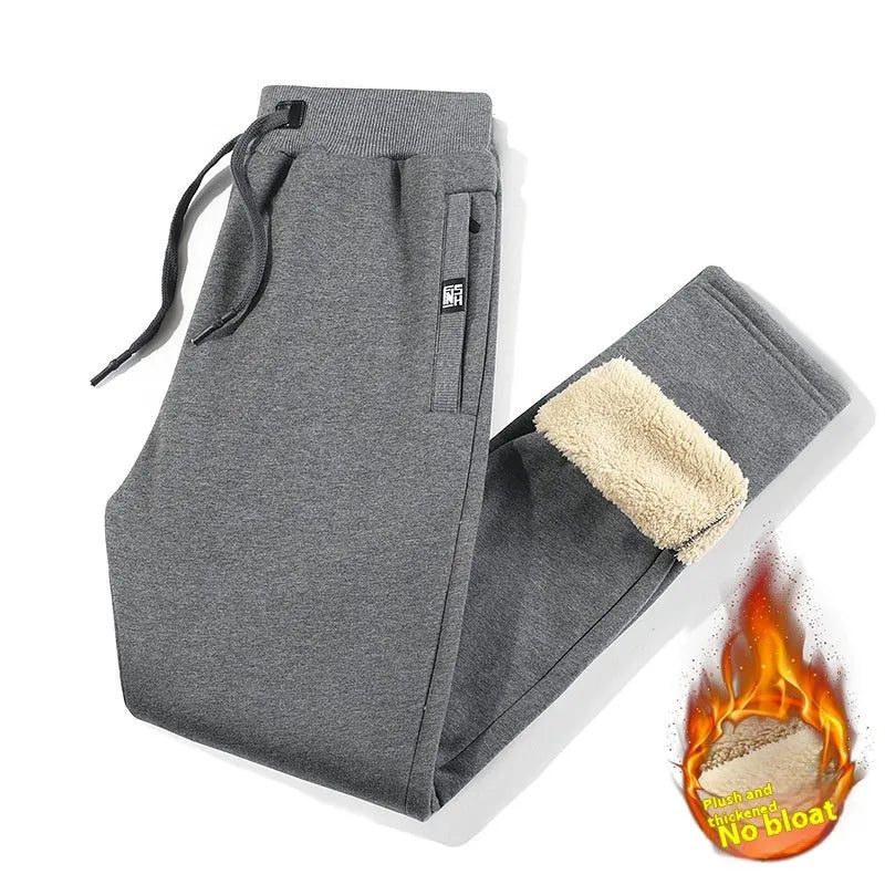 Men's grey fleece-lined cotton track pants with elastic waistband shown on hanger