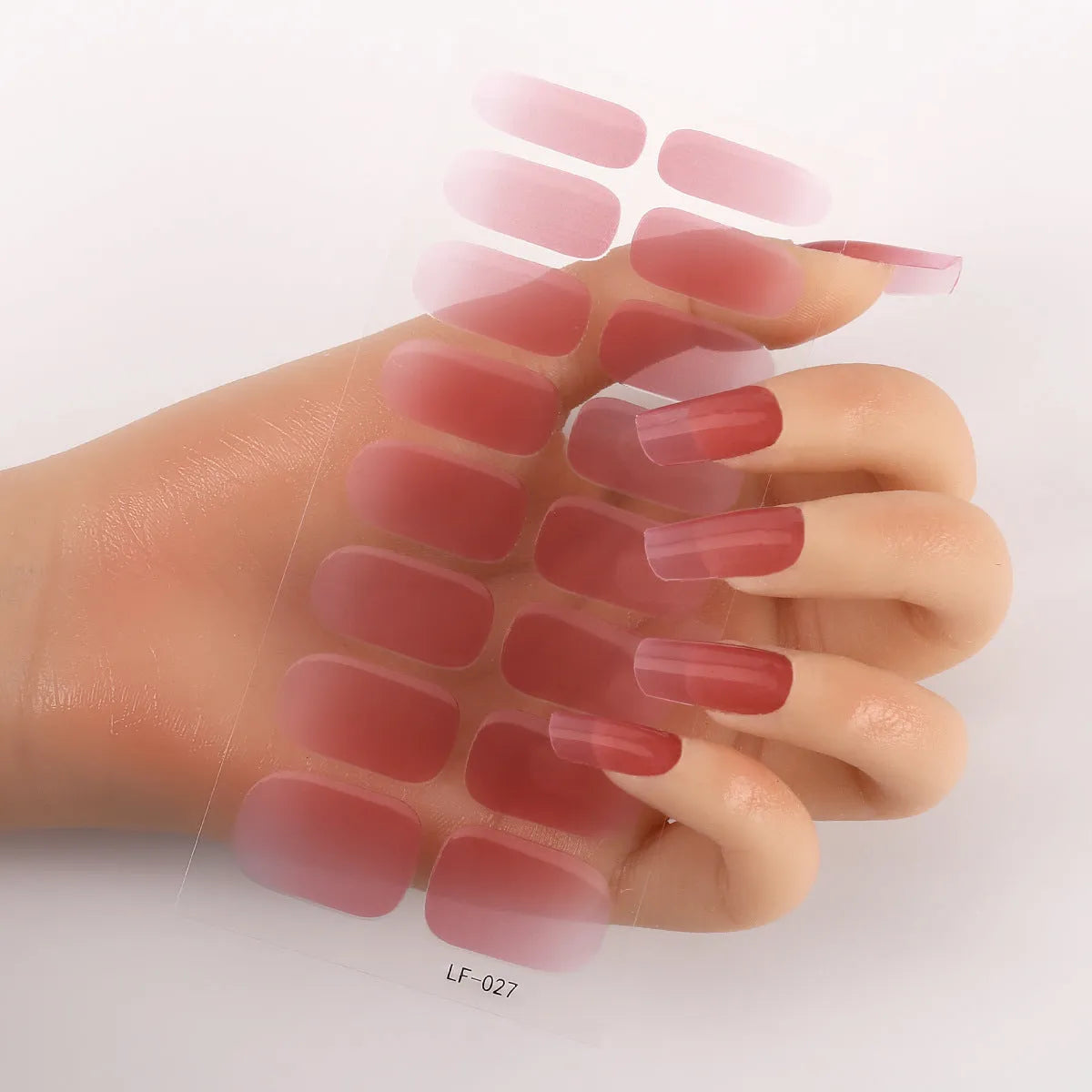 Set of 16 solid colour nail art stickers showing floral, geometric, and pattern designs for manicure application