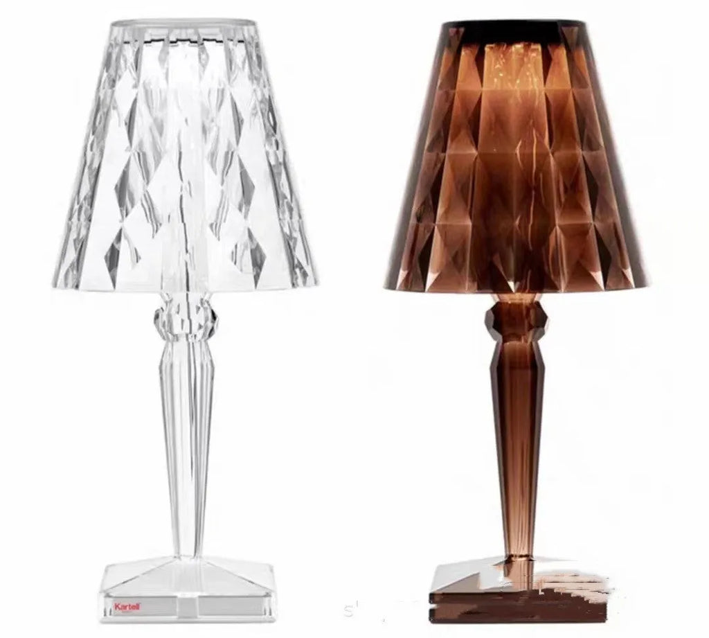 Rose gold portable touch projection night light on a wooden surface.