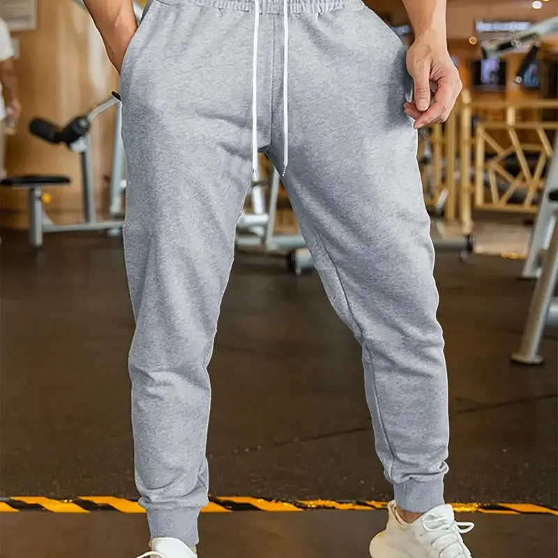 Men's linen-style leisure trousers with elastic drawstring waistband and loose fit design