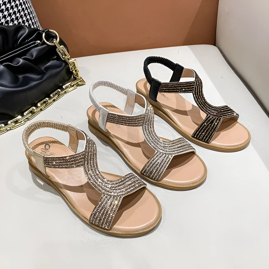 Women's patent leather summer sandals with rhinestone detail on round toe, shown in gold colour