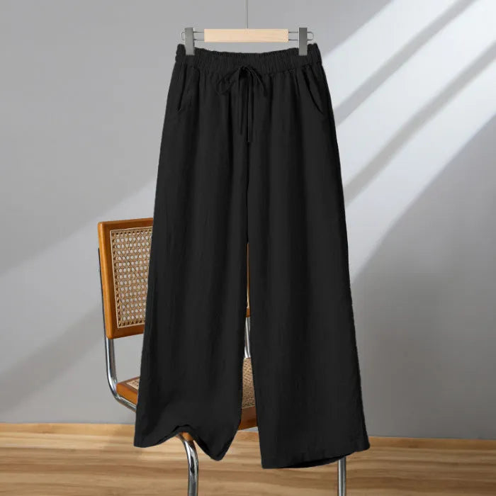 Women's apricot straight-leg casual trousers with elastic drawstring waist laid flat.