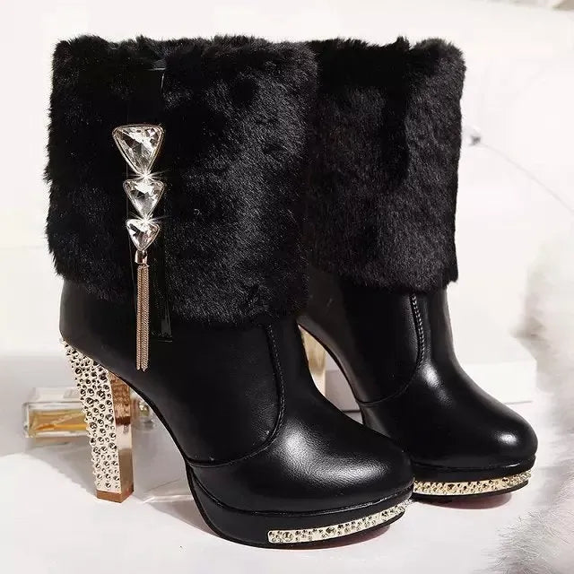 Women's black and white ankle boots with a chunky high heel on a solid colour background.