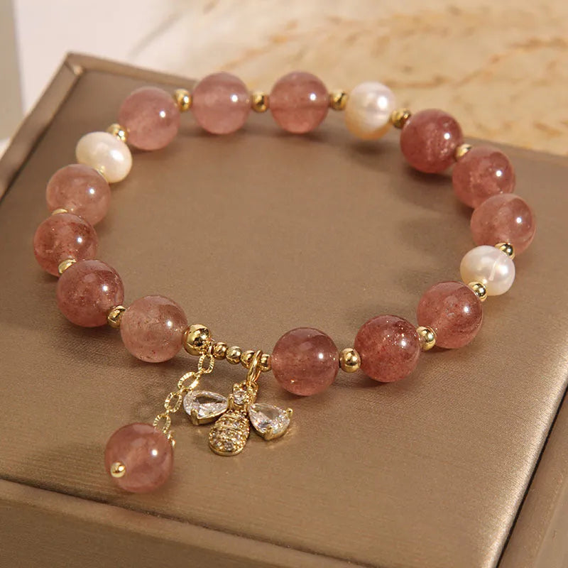Women's strawberry quartz and freshwater pearl bracelet with zircon bee charm in Japanese-Korean jewellery style