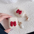Beige red bow shell TPU AirPods protective case showing clamshell design