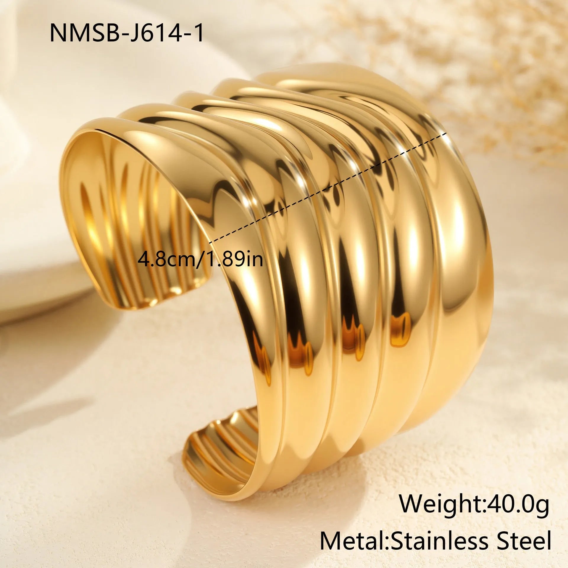Gold plated stainless steel wide bracelet for women with geometric wave design and niche opening clasp
