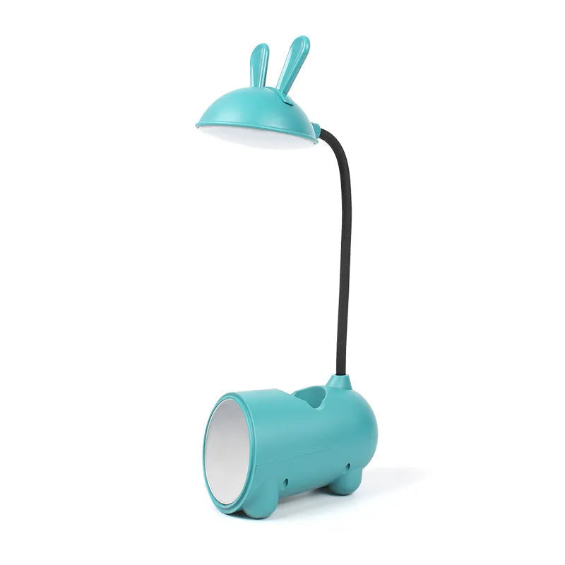 Green cartoon-themed USB table lamp with pen container base on desk