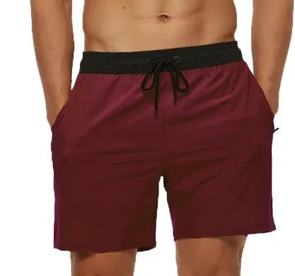 Men's blue running shorts with stitching waistband, zipper pocket, and drawstring for fitness activities