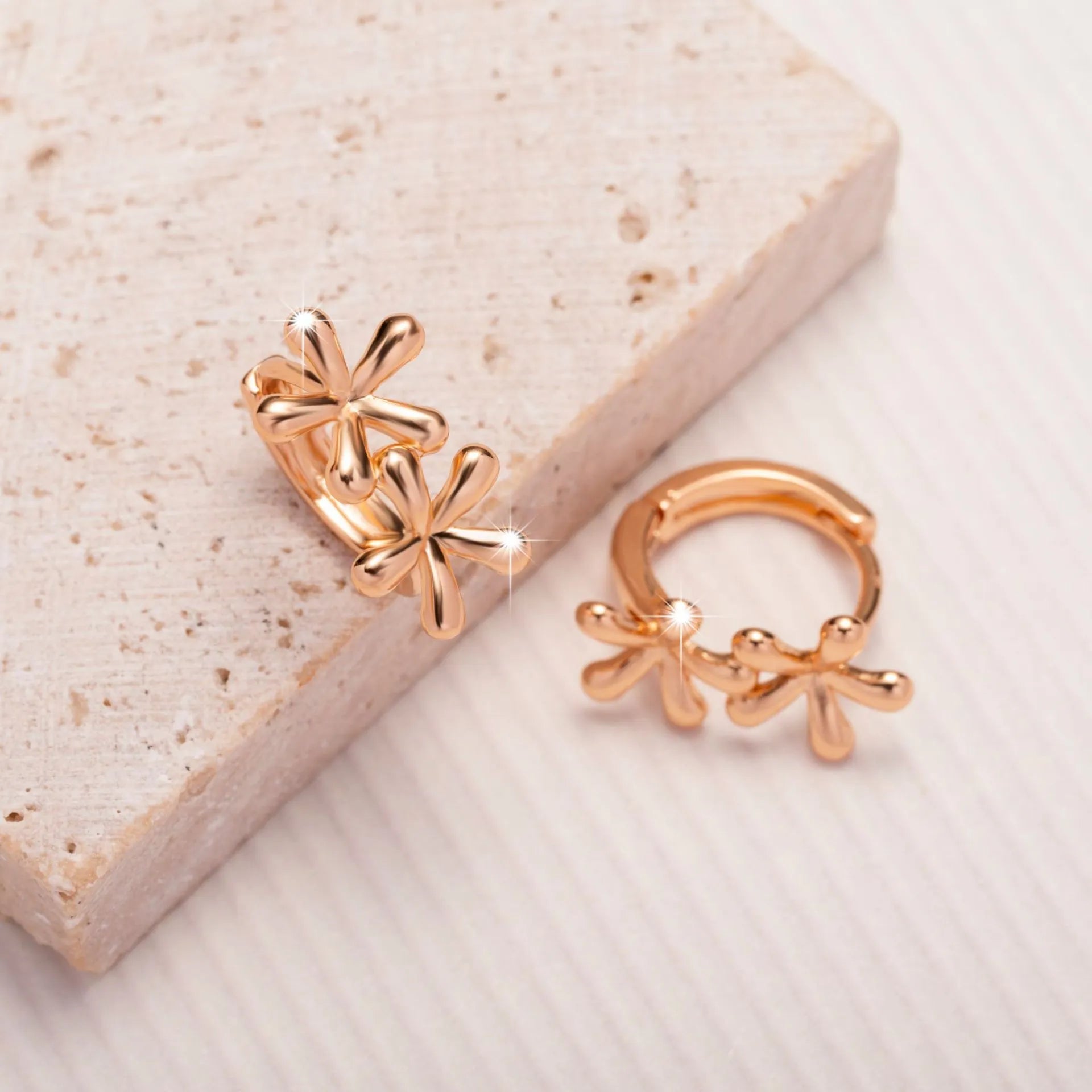 Rose gold circular stud earrings with a waterdrop flower design for women.