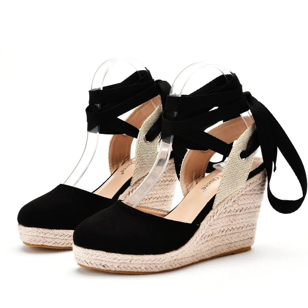 Women's red bohemian wedge sandals with buckle strap, tassel detail, and a fish mouth toe.
