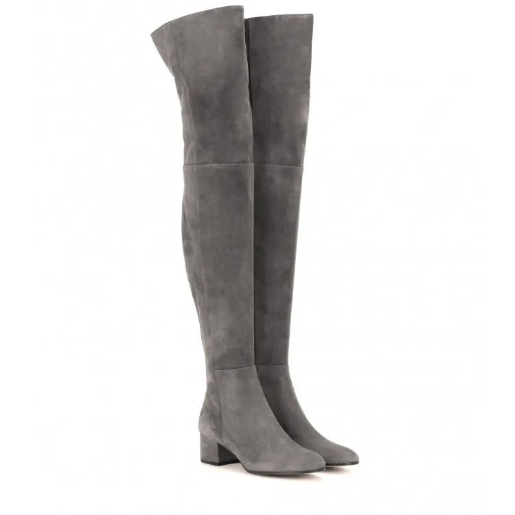 Grey suede women's over the knee flat boots with a pointed toe and low block heel on a neutral background.