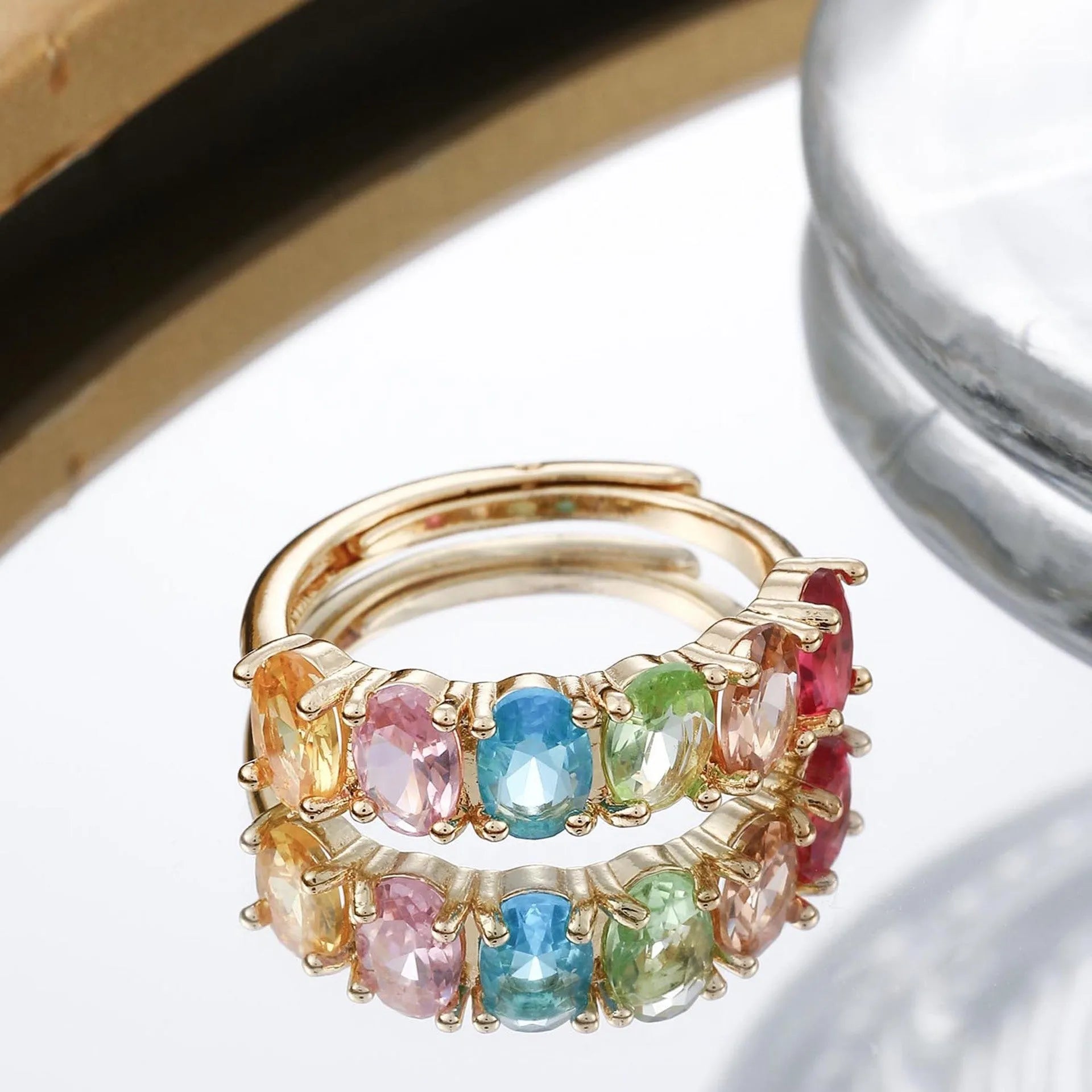 Gold electroplated women's zircon ring with adjustable size on display