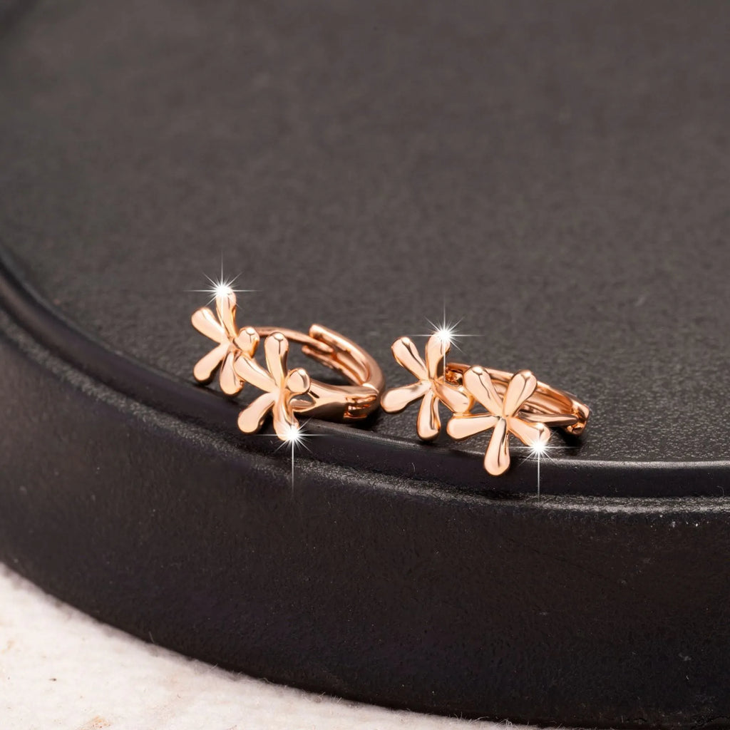 Rose gold circular stud earrings with a waterdrop flower design for women.