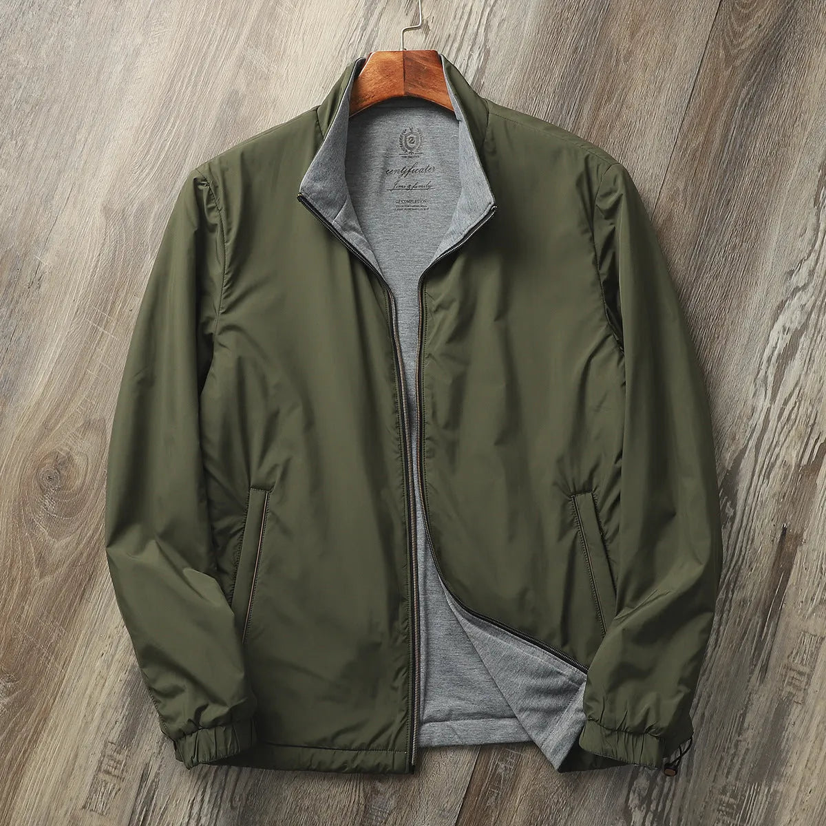 Men's simple stand collar casual jacket in polyester blend fabric, shown on a hanger.