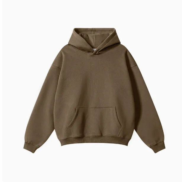 Man wearing a loose-fit grey cotton hooded sweater with drop-shoulder sleeves.
