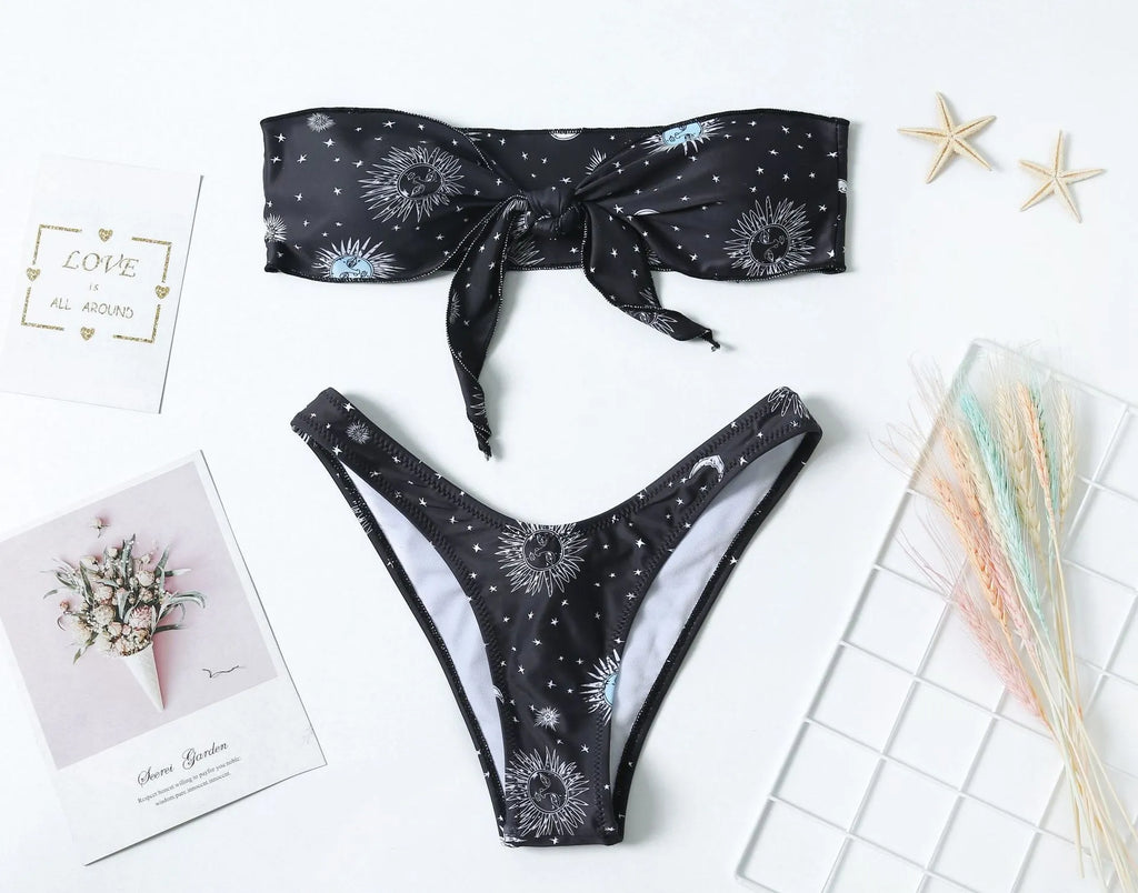 Black bikini print one-piece swimsuit with a split tube top and backless design for women.