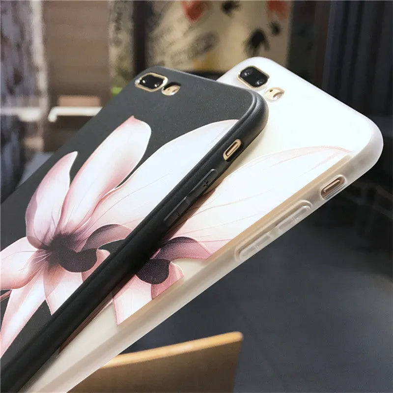 Black embossed iPhone case with a single white floral design on the back.