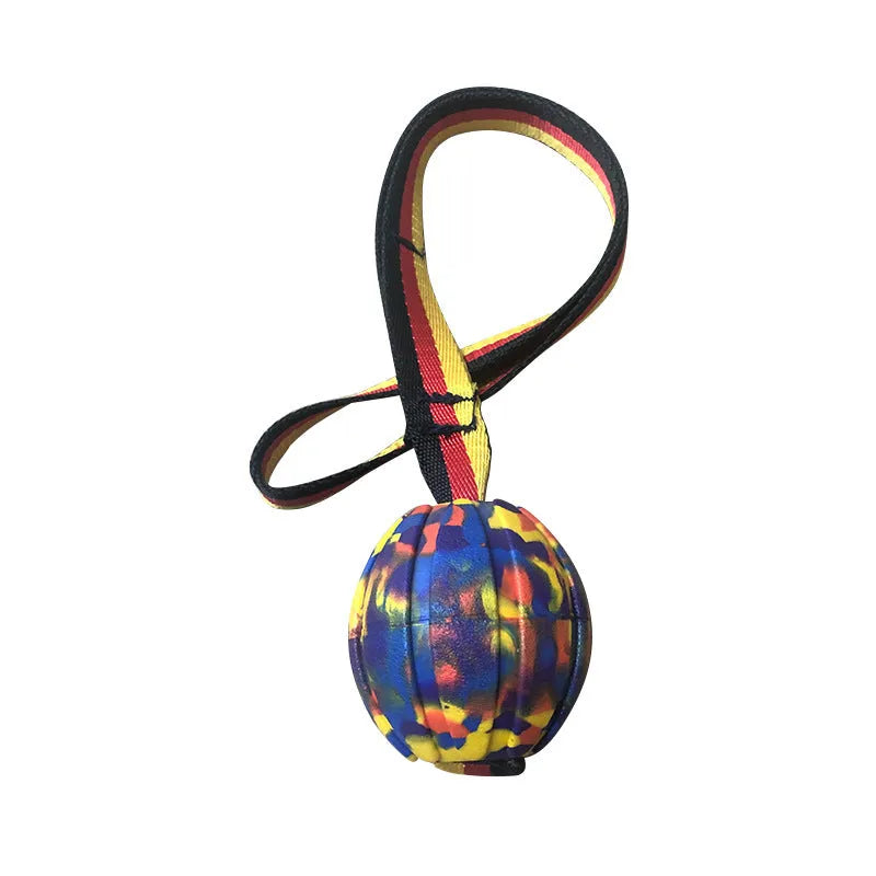 Yellow and camouflage floating EVA foam dog balls with tether strings in three different sizes on a blue background.