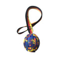 Yellow and camouflage floating EVA foam dog balls with tether strings in three different sizes on a blue background.