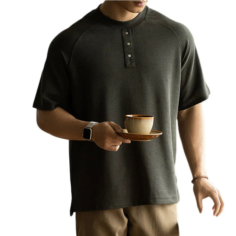 Women's loose grey casual pullover top with raglan sleeves on a hanger.