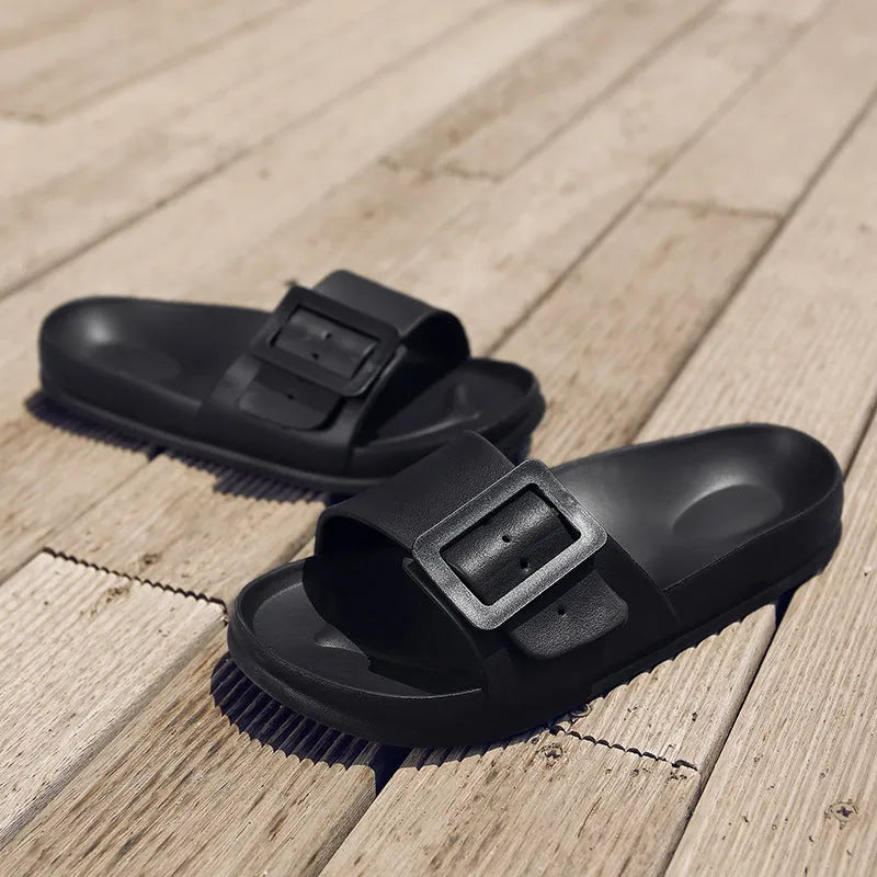Women's grey blue buckle slippers with a flip-flop design and soft EVA sole on a white background
