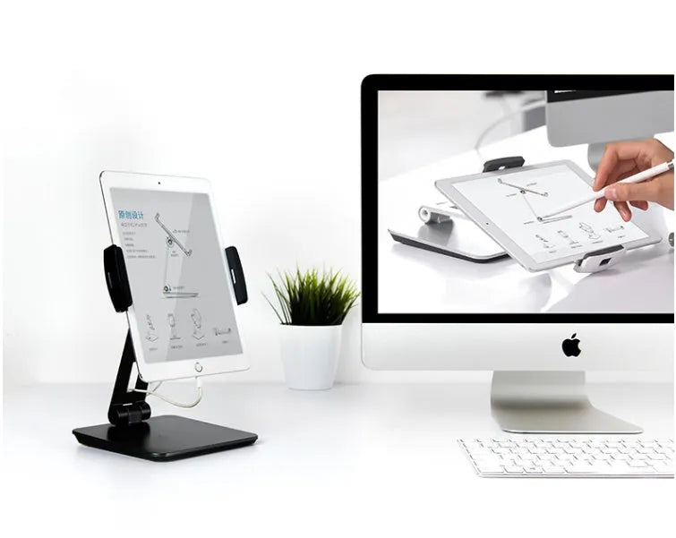 Silver foldable aluminium stand holding a tablet at an angle on a desk