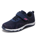 Women's low-top wedge sneaker in grey purple with mesh upper and Velcro strap.