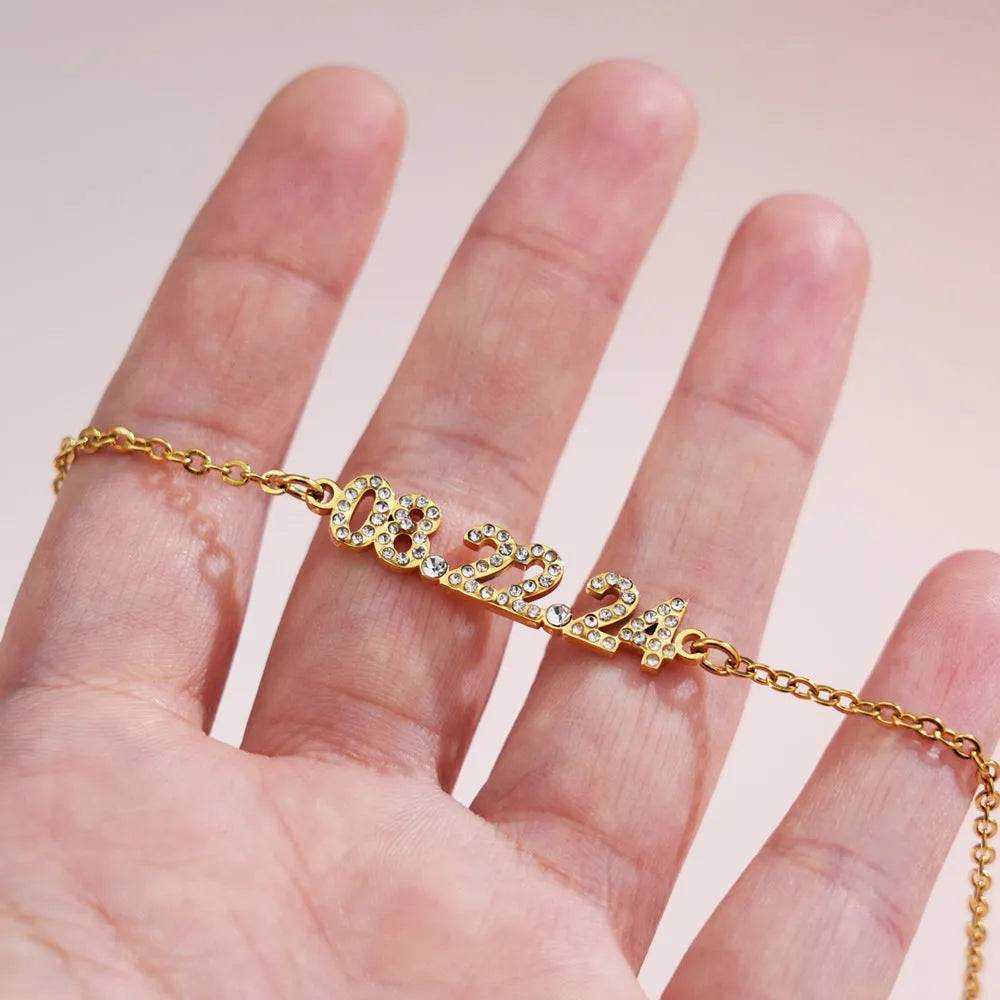 Stainless steel digital bracelet with diamond-set numbers on display, shown in a gold tone finish.