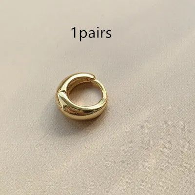 Women's minimalist copper water drop earrings in gold or silver, shown in large, medium, and small sizes.