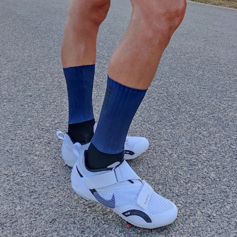 Cycling socks in orange, black, purple, white, grey, or dark blue with moisture-wicking fabric