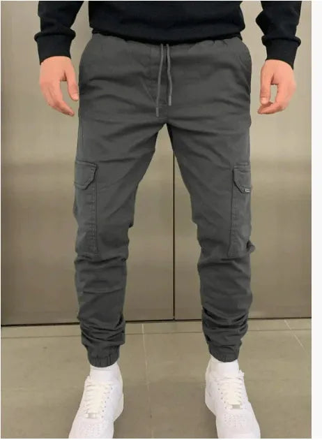 Men's loose polyester trousers with patch pockets and elastic waistband in light blue colour