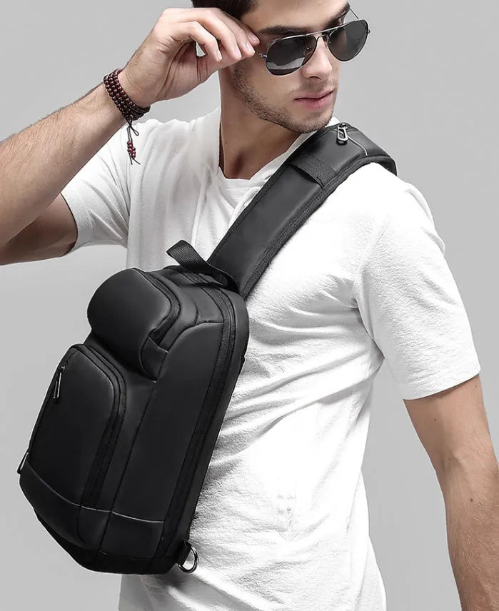 Black PVC outdoor shoulder bag with air cushion strap and multiple compartments
