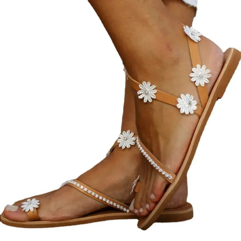 Brown flat-bottom Roman sandals with flower pattern and herringbone toe design