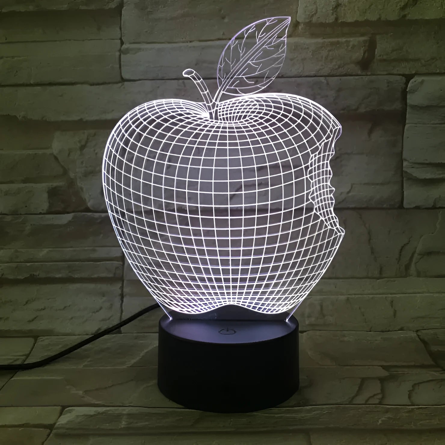 3D fruit-shaped night light with colourful LED glow on a tabletop.
