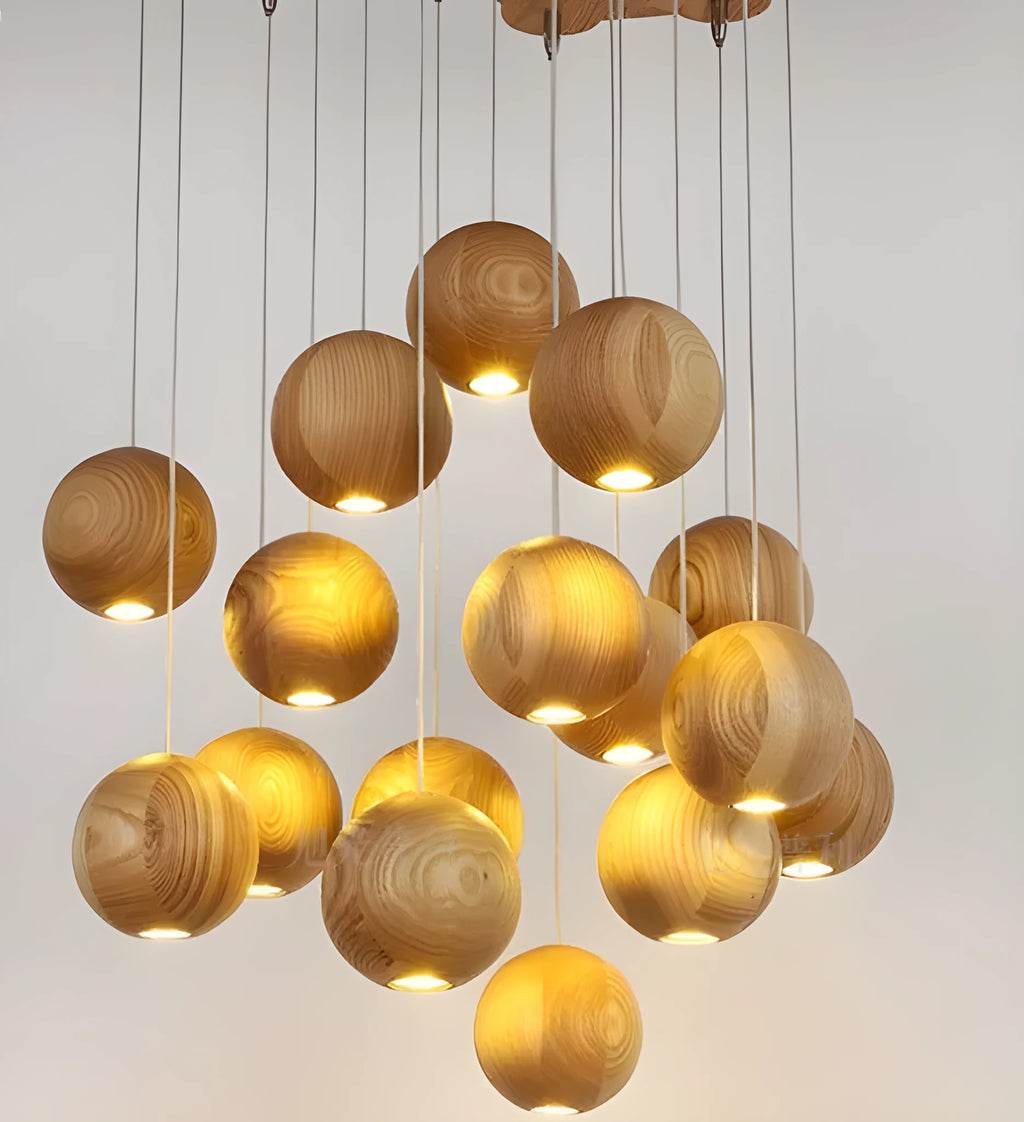 Nordic solid wood ball chandelier hanging lamp with adjustable cord over a dining table.