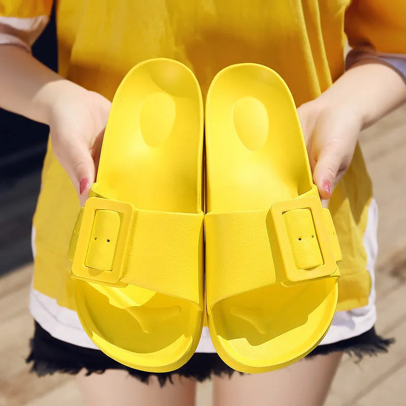 Women's grey blue buckle slippers with a flip-flop design and soft EVA sole on a white background