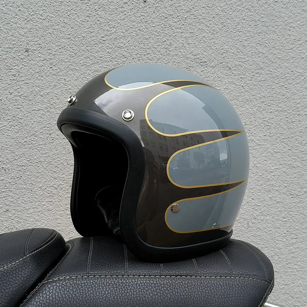 A cement grey retro-style motorcycle half helmet with a floral pattern on the side, showing its open-face design.