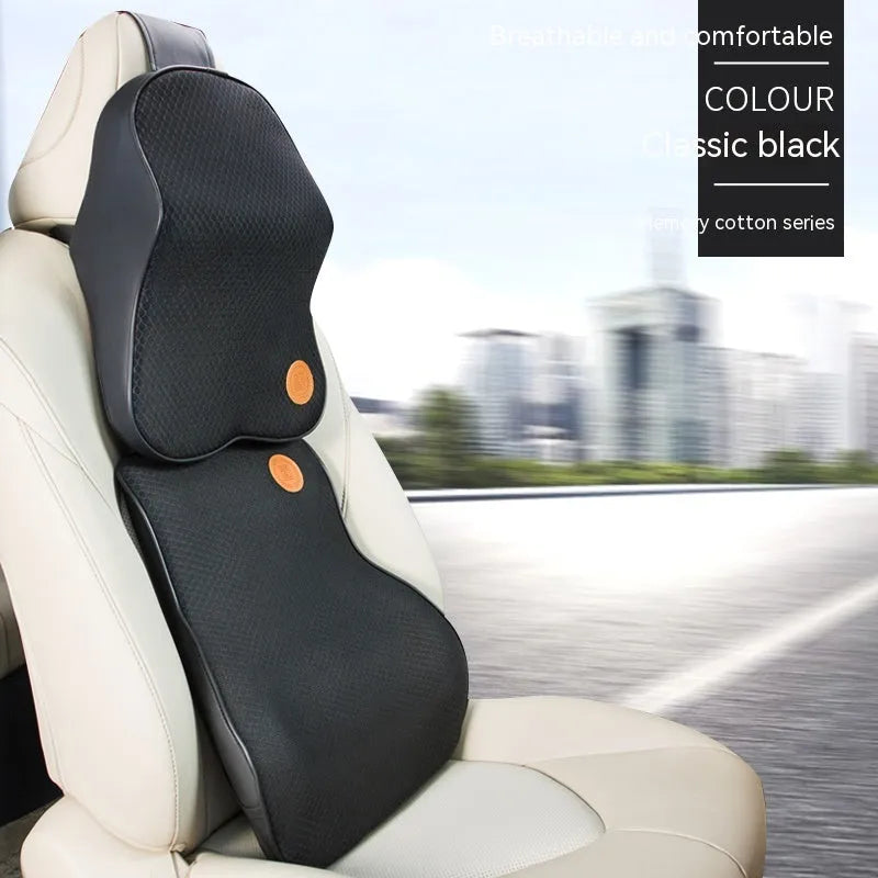 Black and brown memory foam car headrest and lumbar support pillows on a car seat.