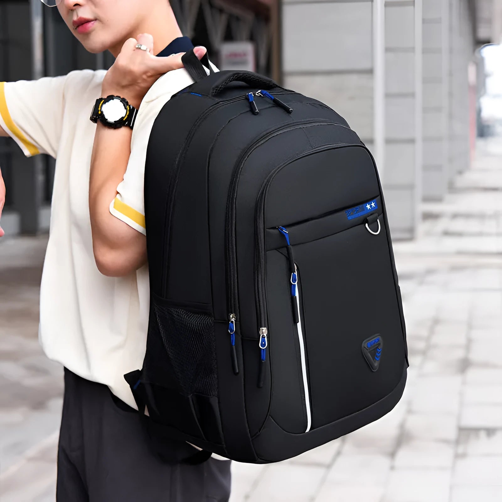 Men's large Oxford cloth schoolbag in black with letter pattern, showing air pillow belt and splicing detail.